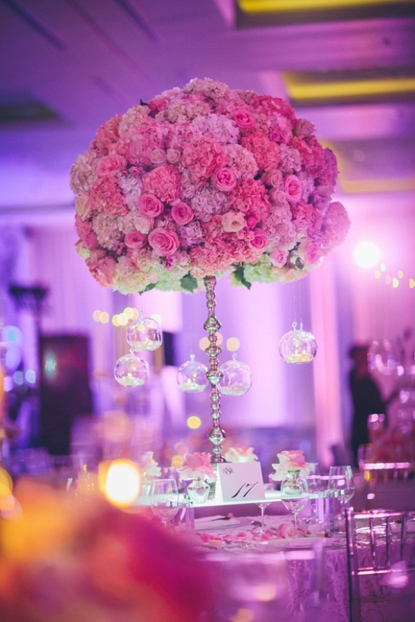 Glamorous tall centerpiece with ombre pink and purple hydrangea and roses and hanging candles