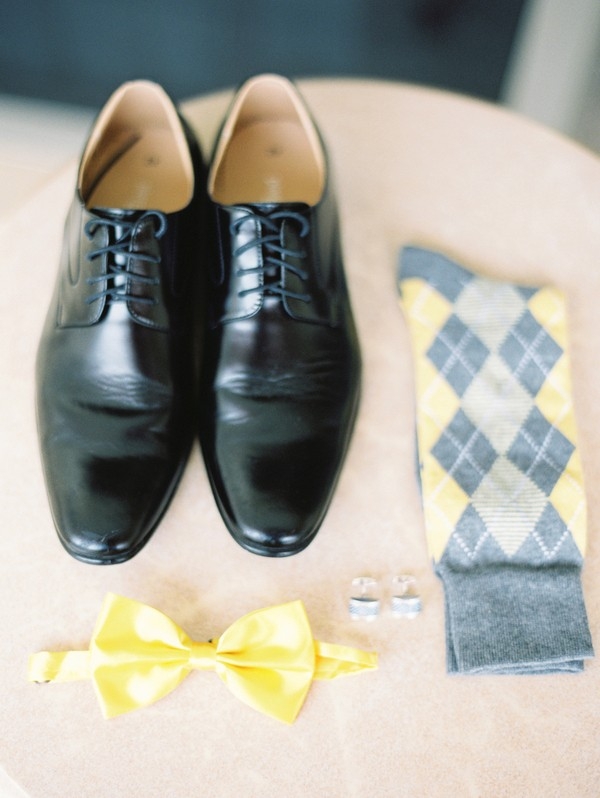 Gray and yellow groom's accessories neatly organized