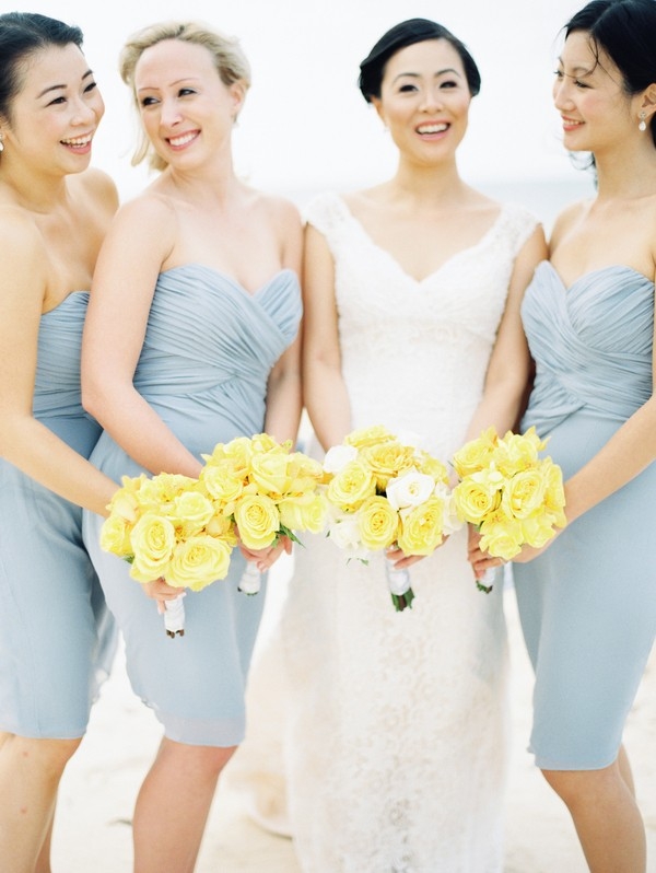 Bridesmaids in gray with yellow rose bouquets