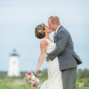 Bride and groom with lighthouse in background