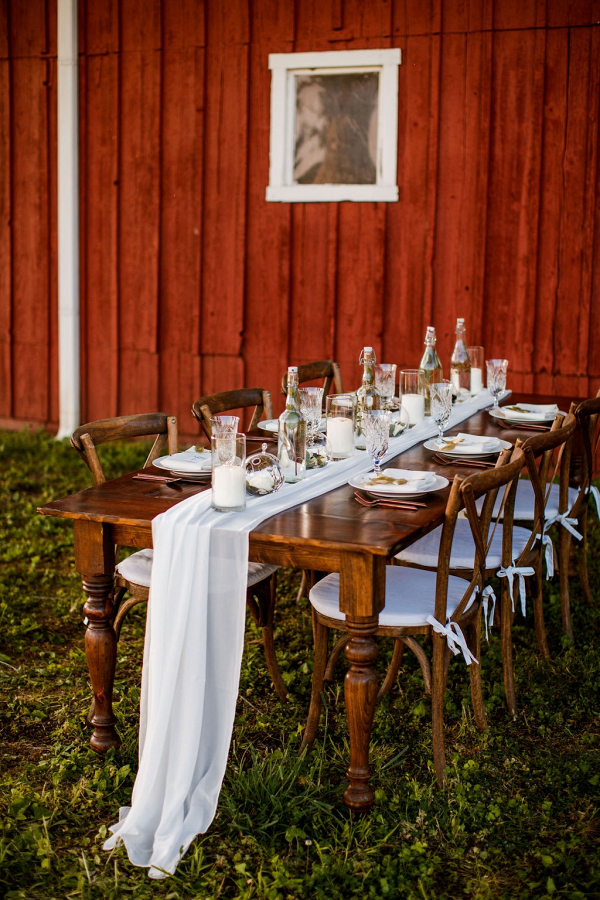 Barn wedding table with bottle centerpieces