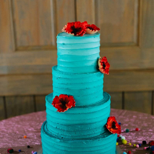 Teal wedding cake with red flowers