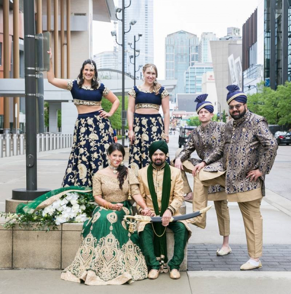 Indian wedding party in blue, gold, and green