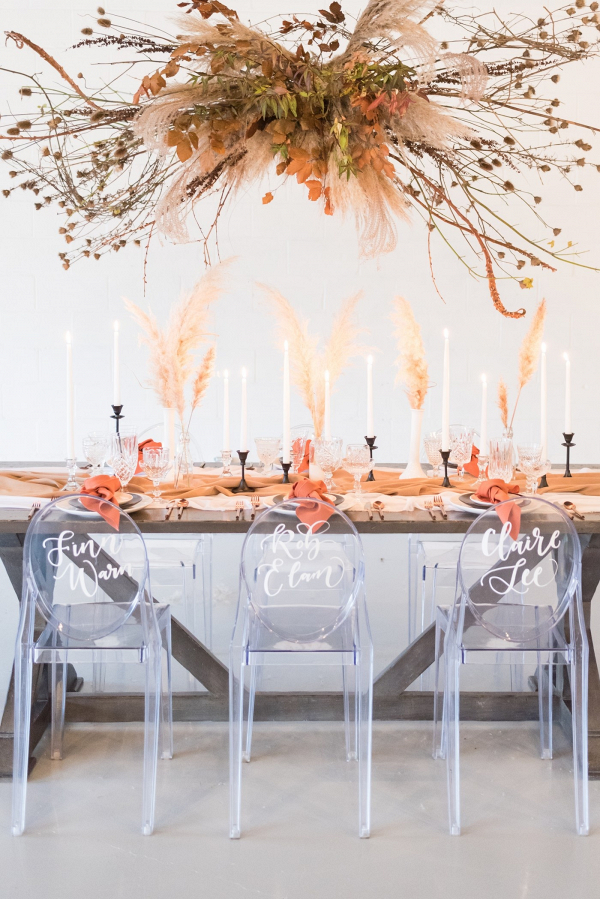 Modern romantic wedding table with suspended greenery