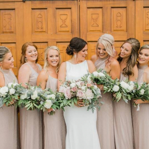 Bridesmaids in long neutral hued gowns