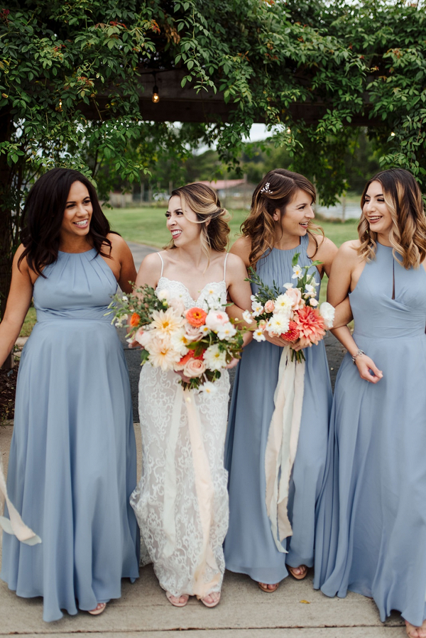 Bridesmaids in long blue dresses