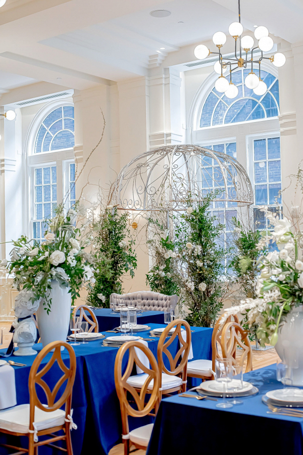 Blue and silver wedding reception with urn centerpieces
