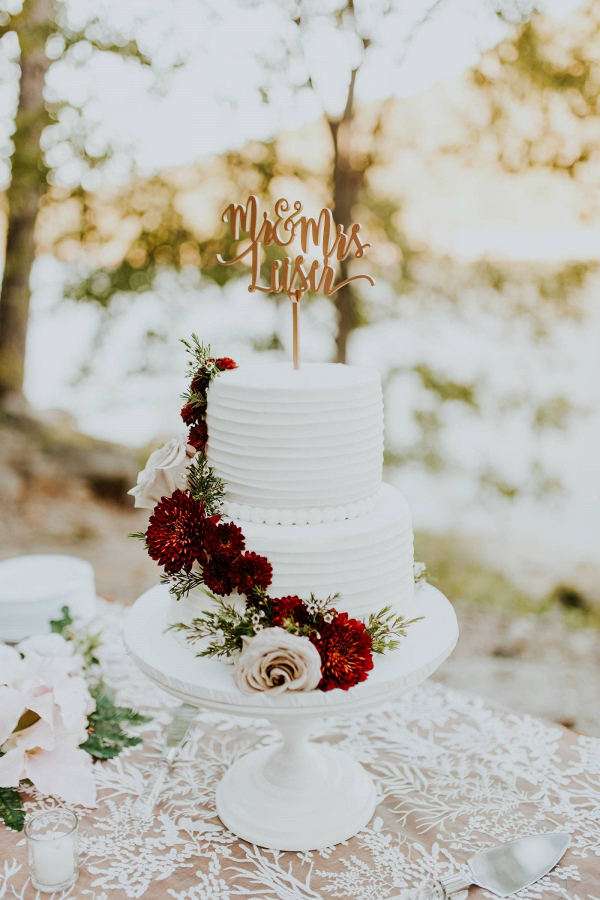 White wedding cake with red flowers