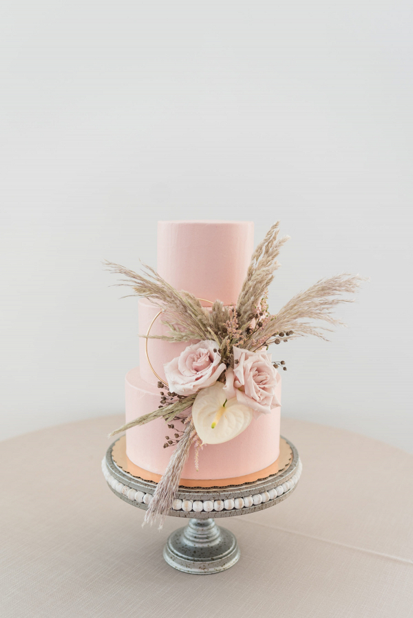 Pink wedding cake with pampas grass