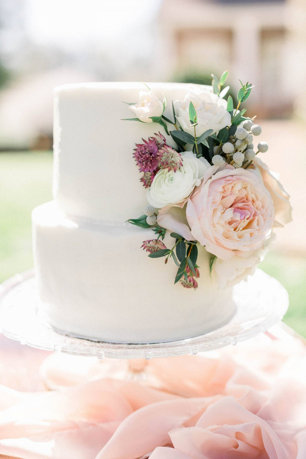 Small white wedding cake with fresh florals