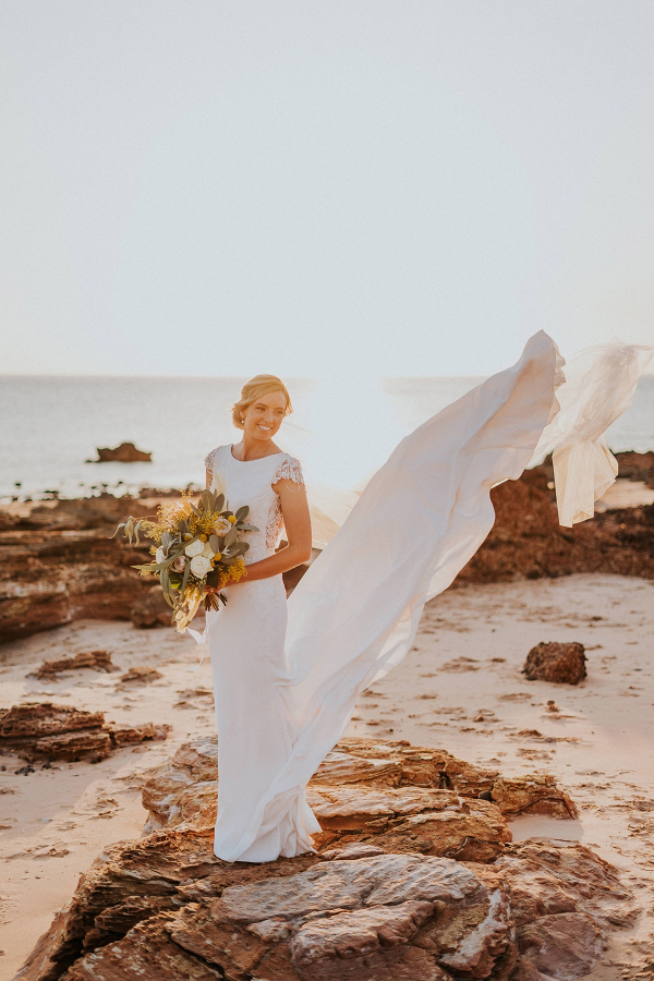 Chic coastal wedding bridal portrait on rocks