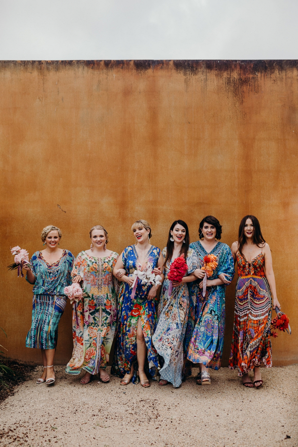Bridesmaids in mismatched colorful print dresses