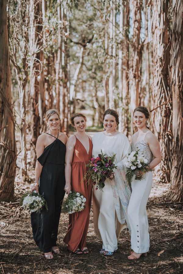 Mismatched bridesmaids in dresses and jumpsuits