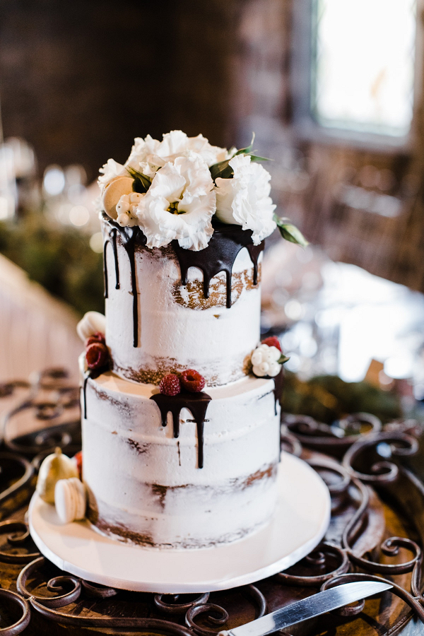 Semi naked drip wedding cake with fresh flower topper