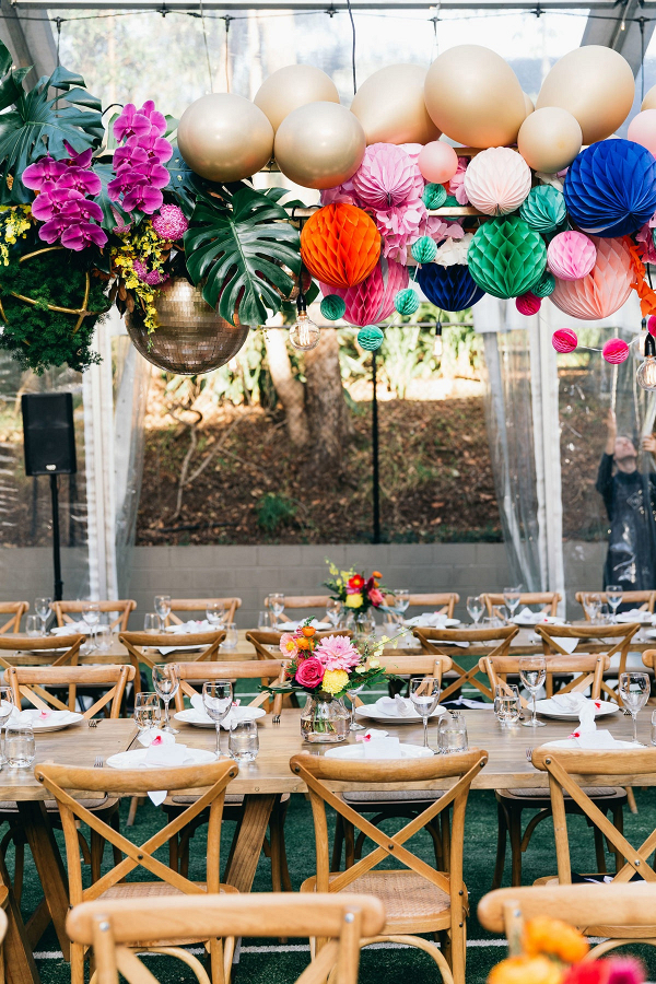 Colorful wedding reception with hanging poms