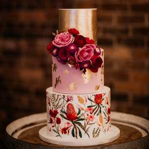 Floral print pink and gold wedding cake