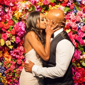 Newlyweds With Bright Floral Wall