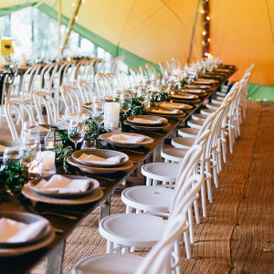 Long table tented wedding reception with suspended greenery