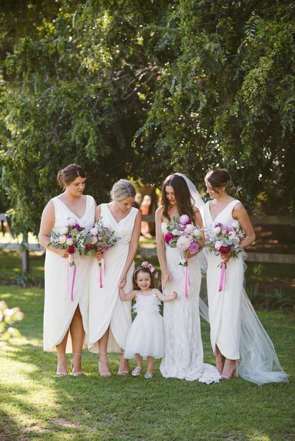Bridesmaids With White Dresses And Pink Bouquets