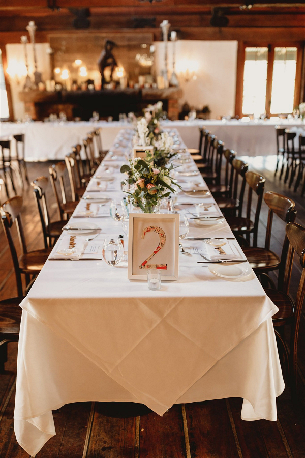 Long table wedding reception with DIY table numbers