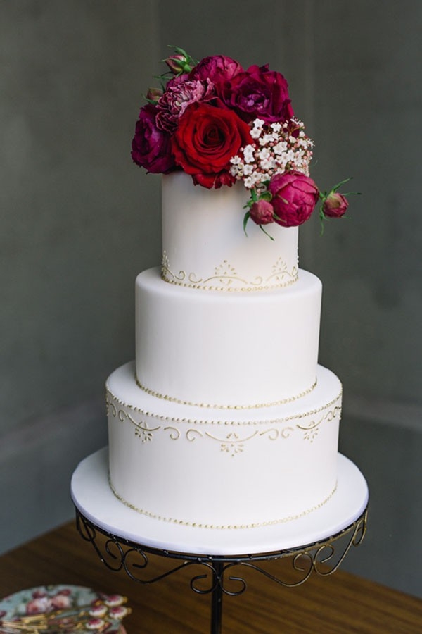 White Wedding Cake With Red Flowers