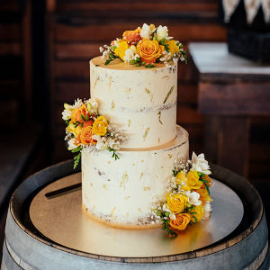 Gold leaf wedding cake with yellow flowers