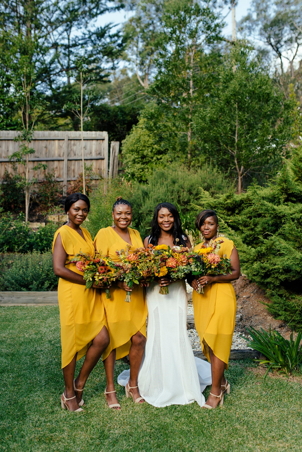Bridesmaids in bright yellow hi-low dresses