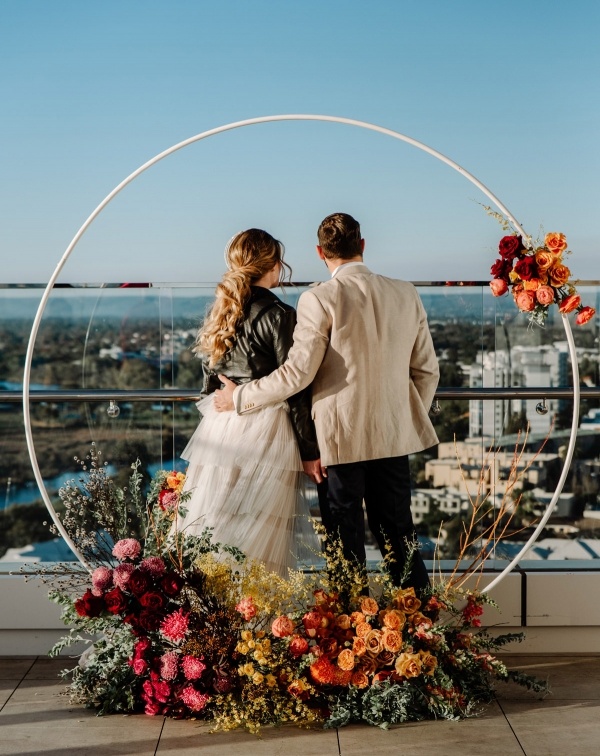 Floral circle arch rooftop wedding ceremony