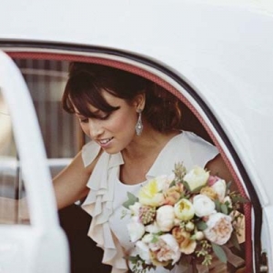 Bride Getting Out Of Wedding Car