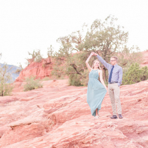 Posing on the rocks with the engagement rock