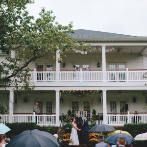Wedding ceremony in front of a beautiful southern home on a lake.