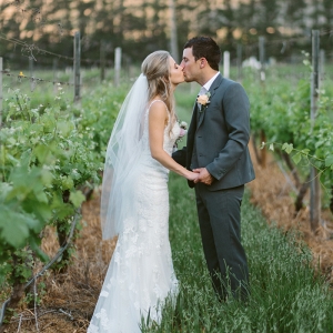 Bride & groom in vineyard