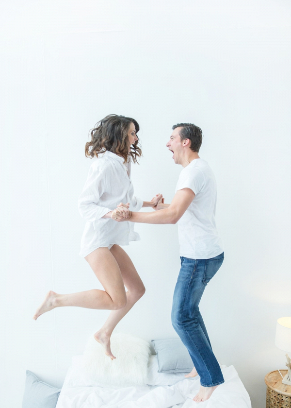 Couple Jumping on Bed