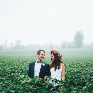 Boho bride and groom in misty field