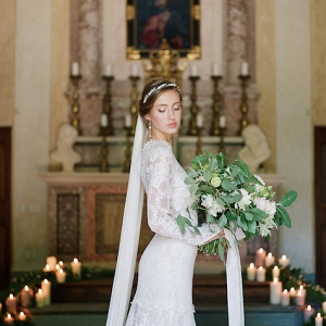 Bride with Greenery Bouquet in Candlelit Church