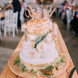 Gold wedding cake with 'yay' topper