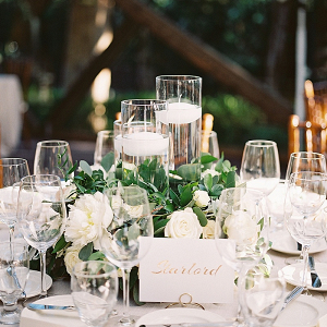 Classic white wedding reception table with floating candles
