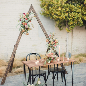 Boho sweetheart table with triangle backdrop