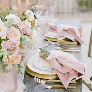 Blush wedding place setting with gold flatware
