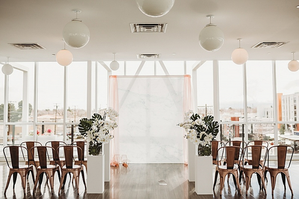 Modern ceremony with draping and copper metal chairs