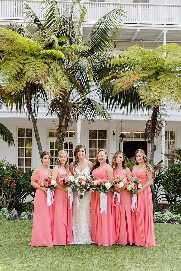 Bridesmaids in bright coral dresses
