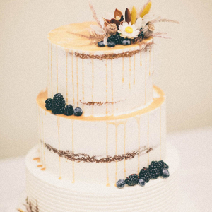 3 tier white wedding cake with raspberries