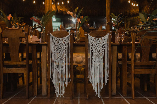 Wooden table and chairs with white macrame