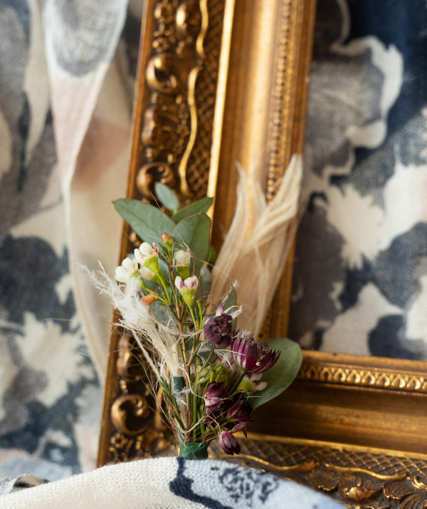 Gold picture frame and a boutonniere