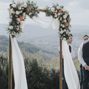 Wooden floral ceremony arbor with the perfect backdrop