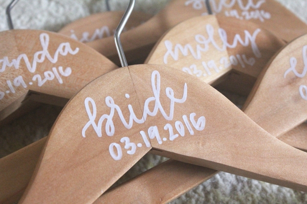 Pretty wedding hangers personalized with painted calligraphy