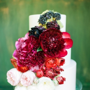 Organic wedding cake adorned with peonies and roses