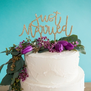 Glittery cake topper that spells out your just-married status
