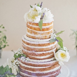Lavender-infused ombre naked cake adorned with white peonies and sprigs of fragrant lavender