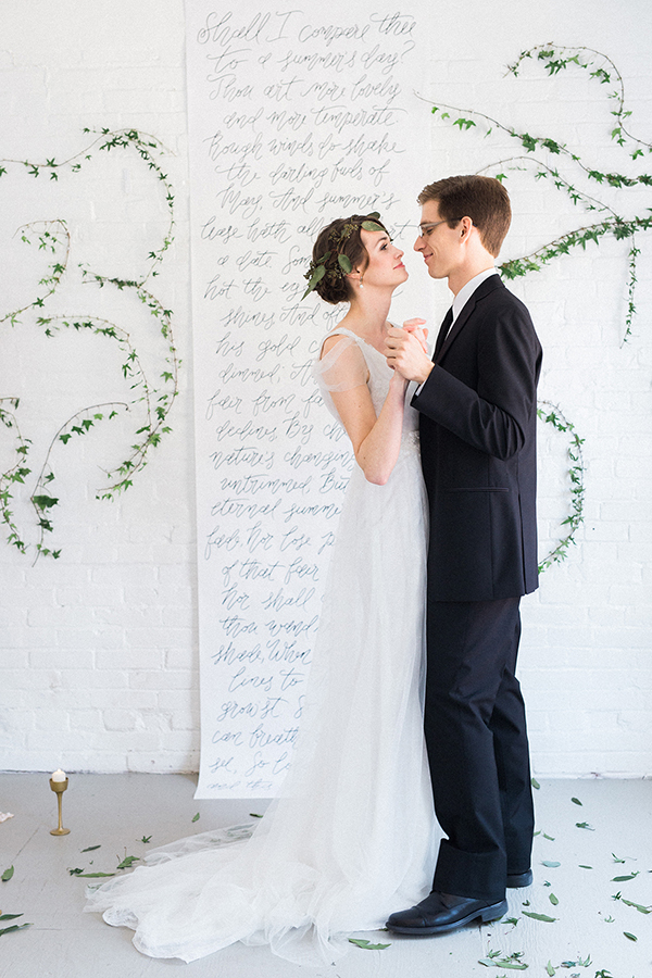 Calligraphed wedding backdrop framed by climbing ivy